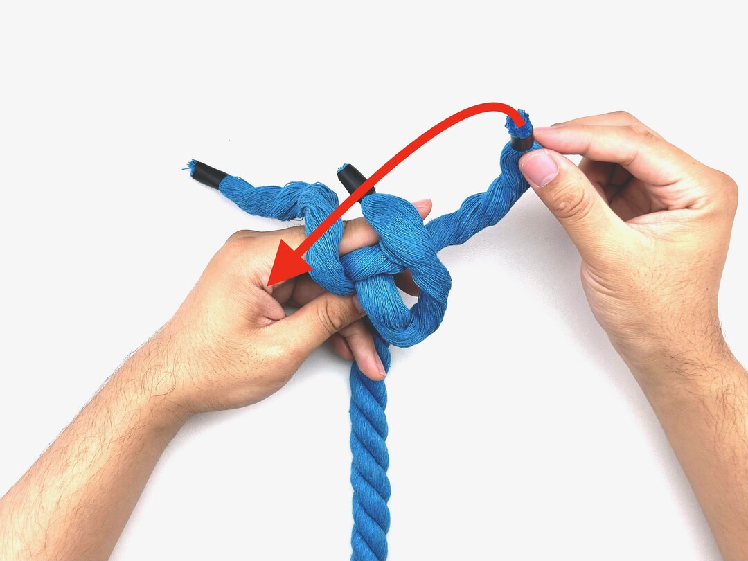 Step 3 of tying the Crown Knot knot - detailed visual instruction