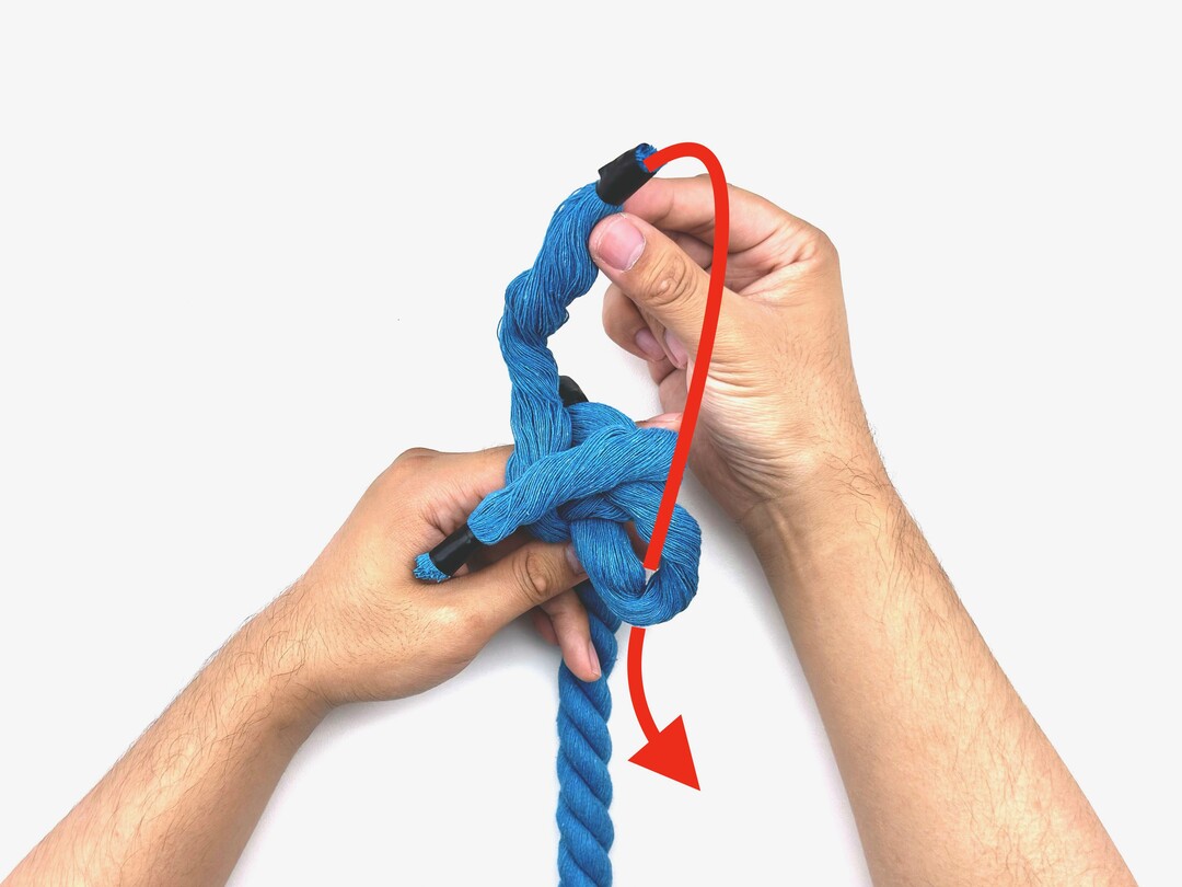 Step 4 of tying the Crown Knot knot - detailed visual instruction