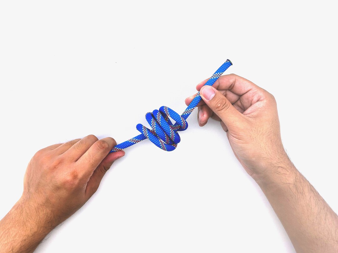 Step 9 of tying the Multiple Overhand Knot knot - detailed visual instruction