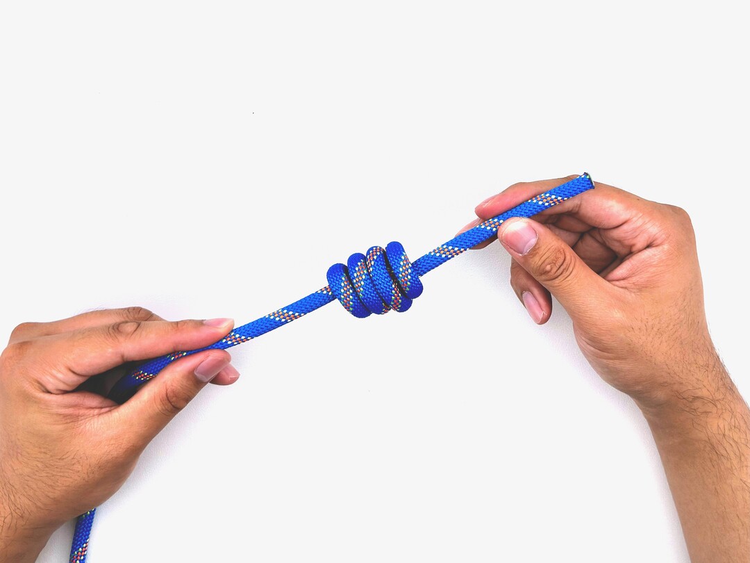 Step 10 of tying the Multiple Overhand Knot knot - detailed visual instruction