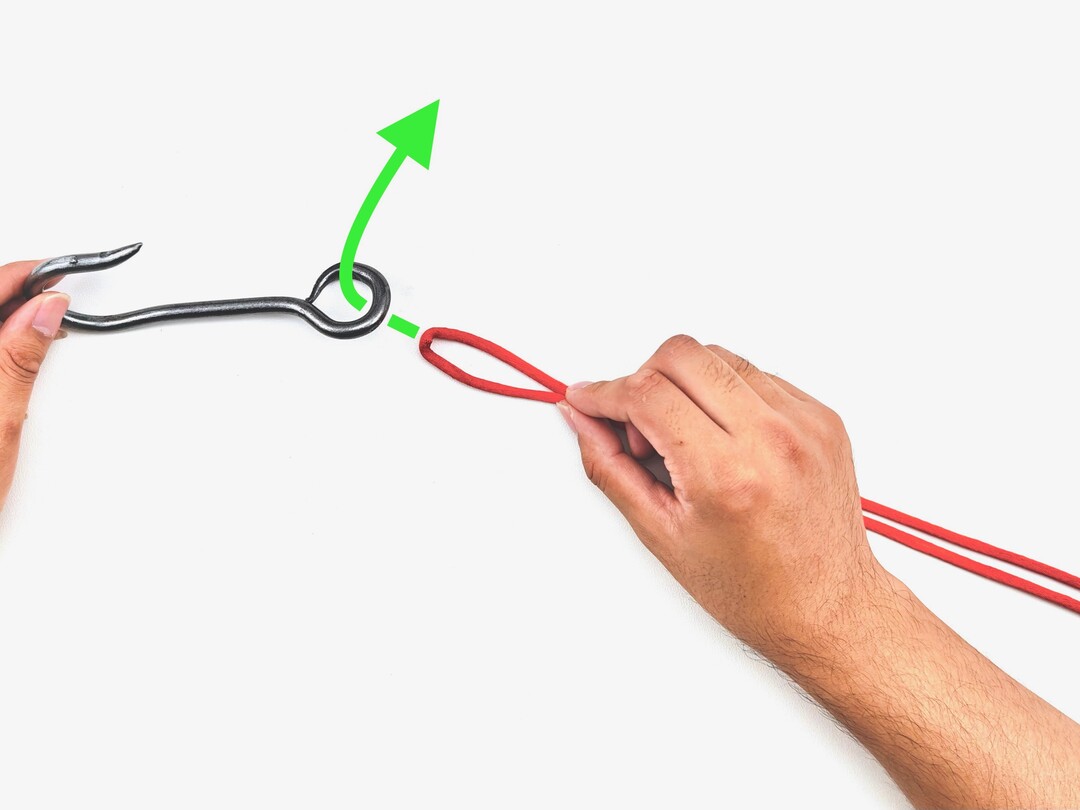 Step 1 of tying the Palomar Knot knot - detailed visual instruction