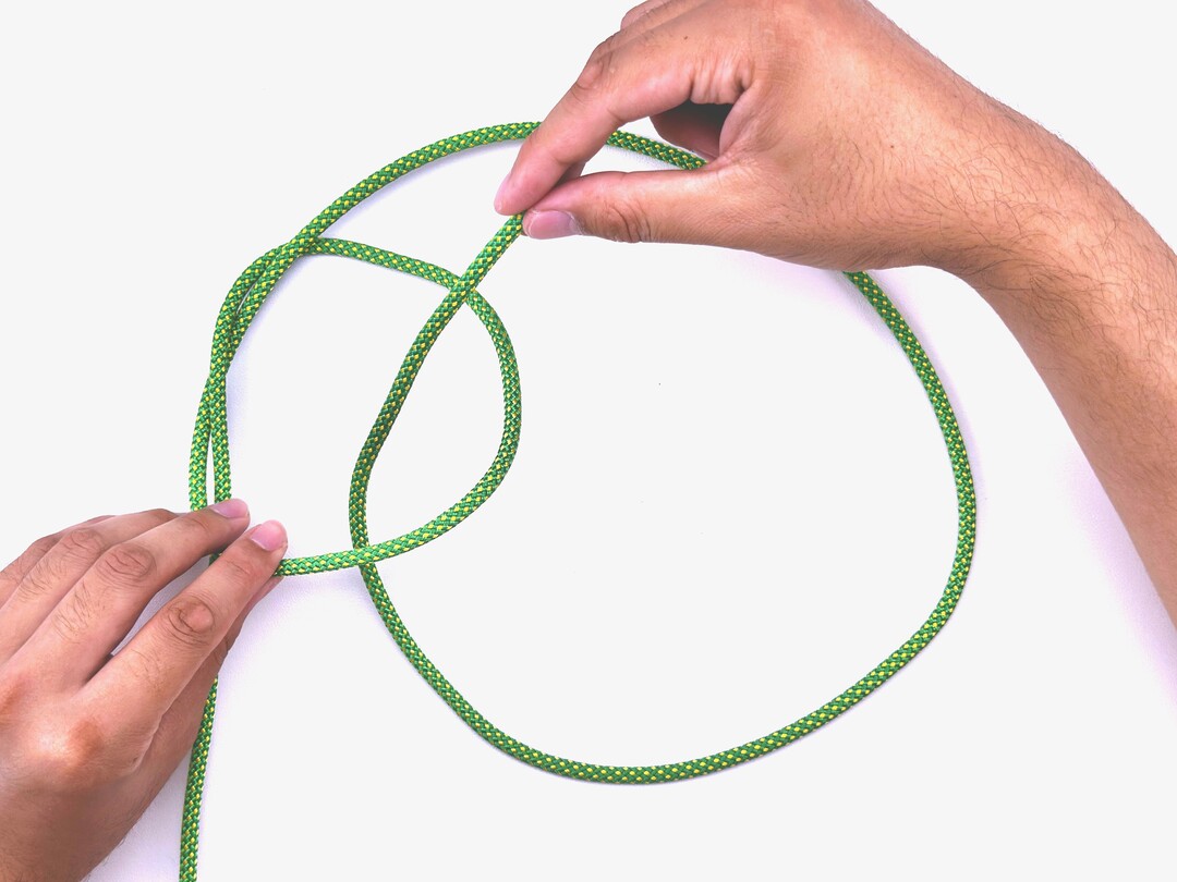 Step 6 of tying the Sailor's Cross knot - detailed visual instruction