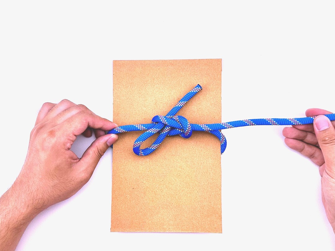 Step 5 of tying the Slipped Square Knot knot - detailed visual instruction
