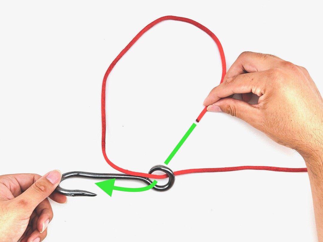 Step 1 of tying the Snelling a Hook knot - detailed visual instruction
