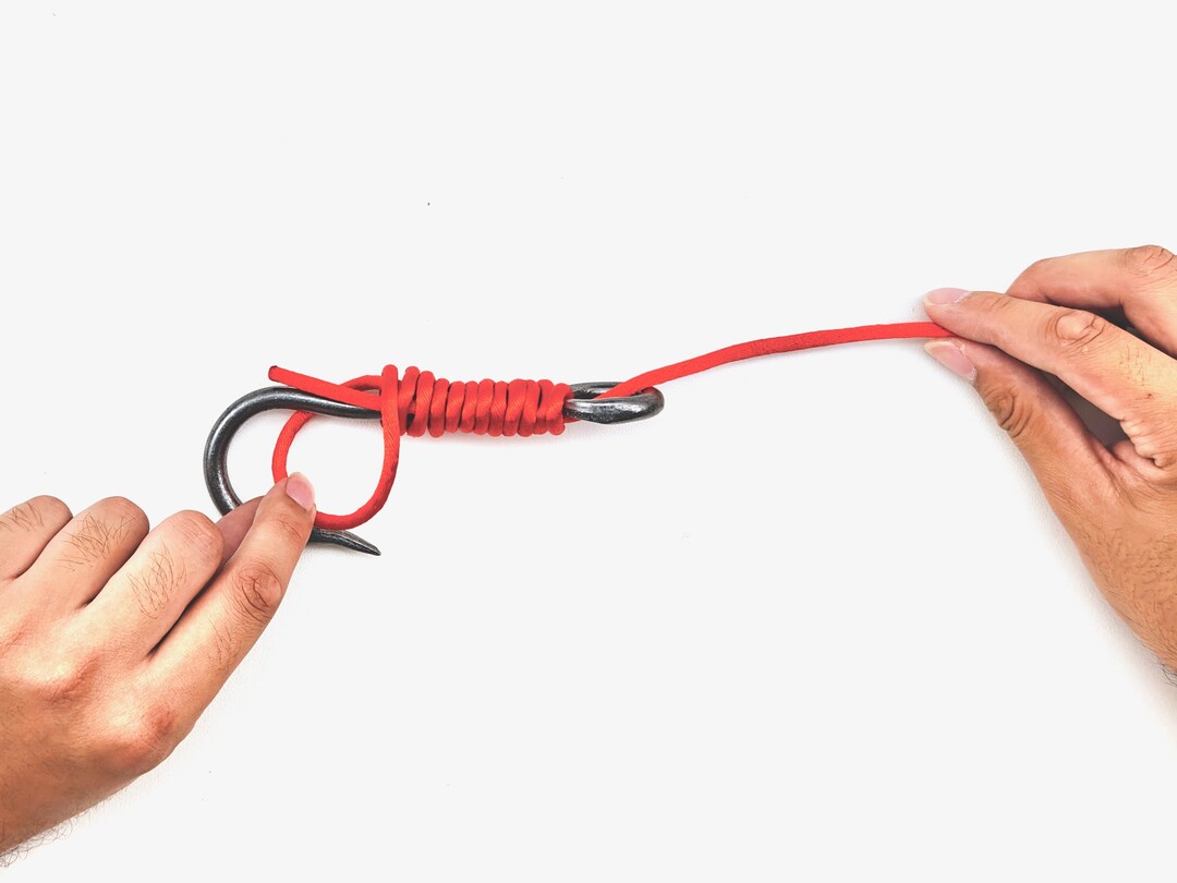 Step 7 of tying the Snelling a Hook knot - detailed visual instruction