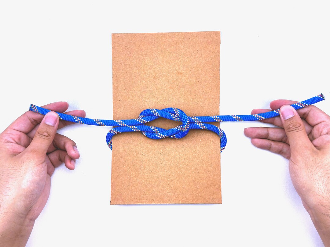 Step 5 of tying the Square Knot knot - detailed visual instruction