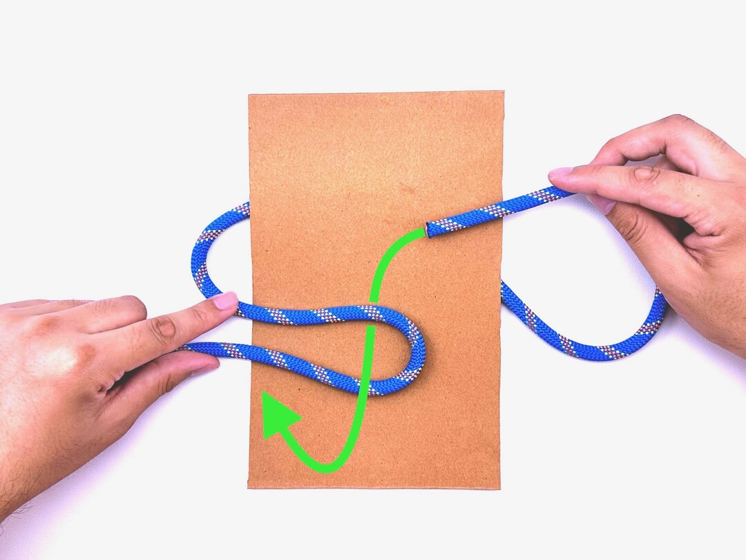 Step 2 of tying the Thief Knot knot - detailed visual instruction