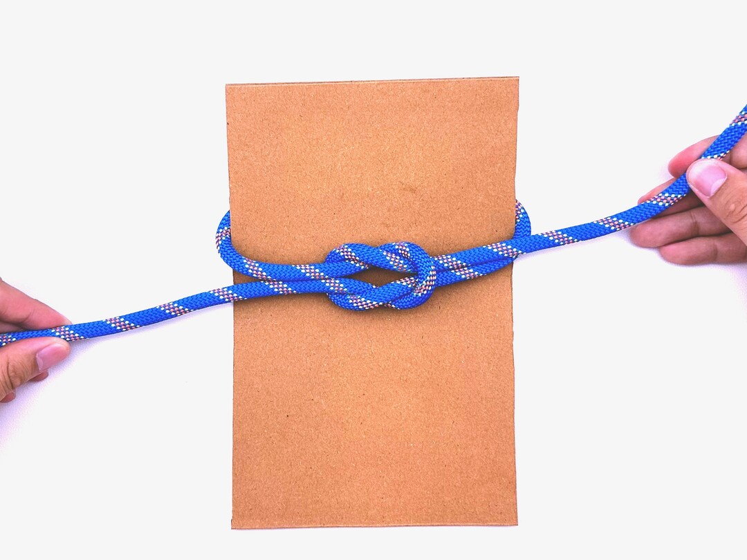Step 6 of tying the Thief Knot knot - detailed visual instruction